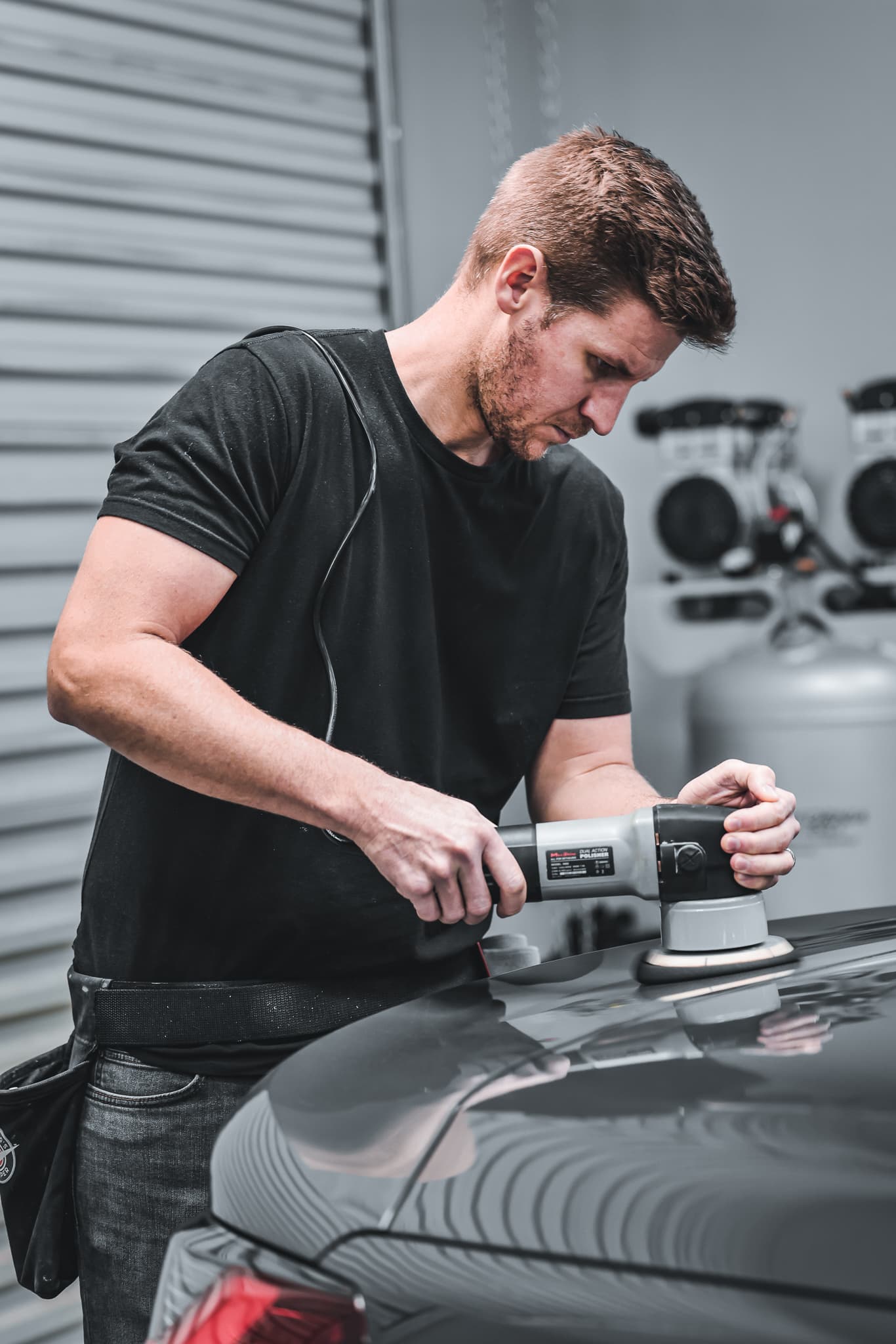 A vehicle being detailed to a clean, glossy finish