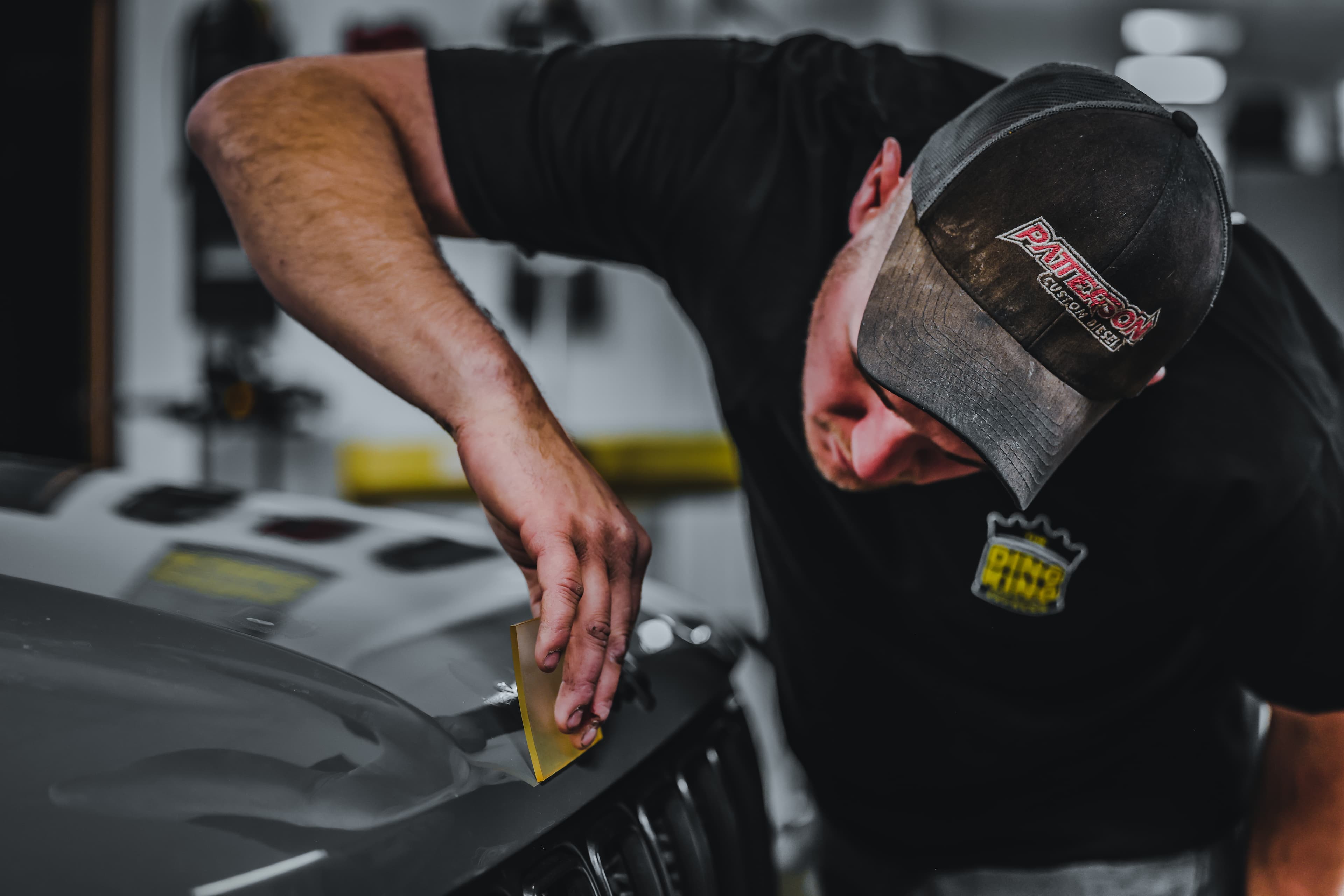 Close-up of a paint chip being repaired on a vehicle