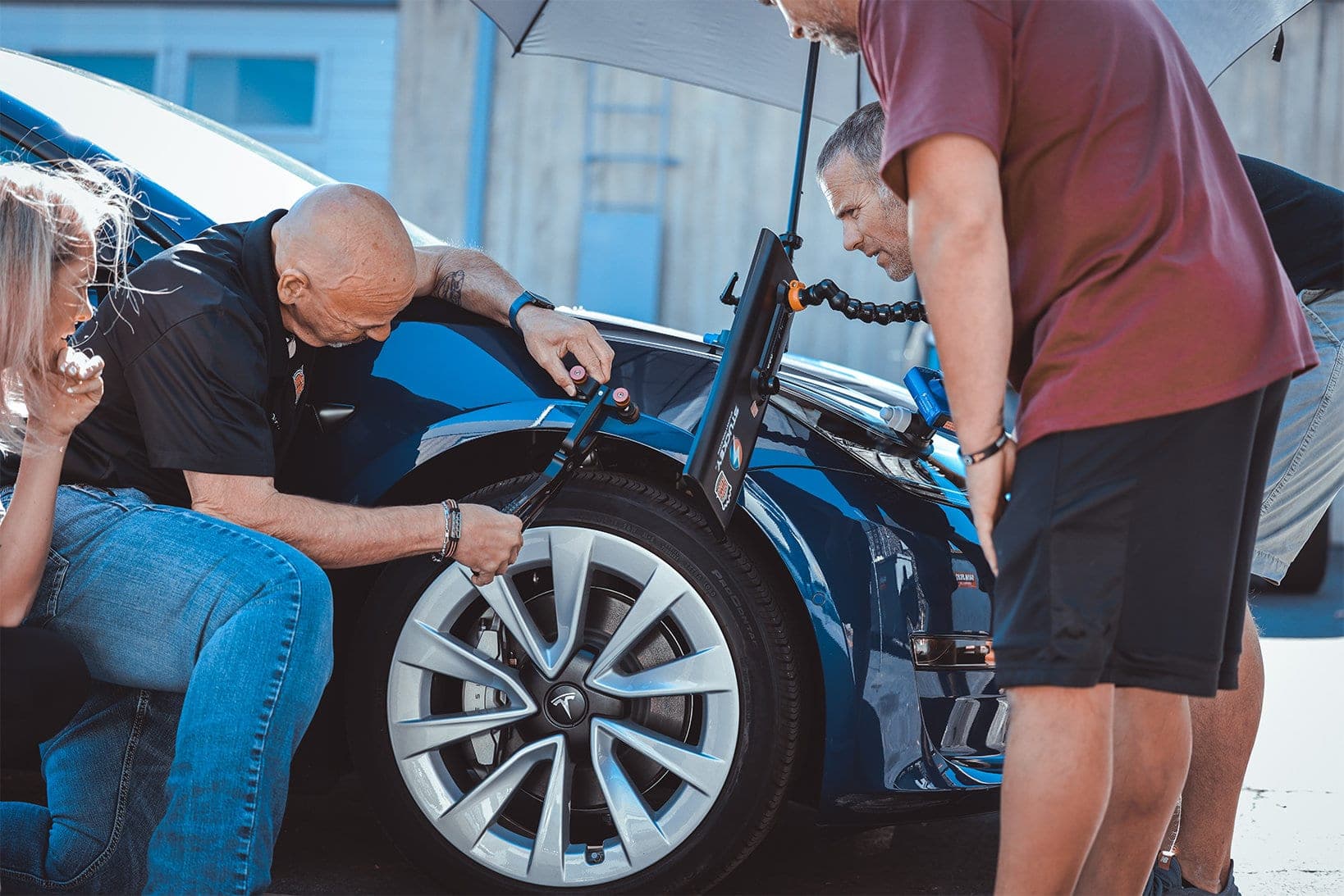 A technician performing hands-on automotive reconditioning work