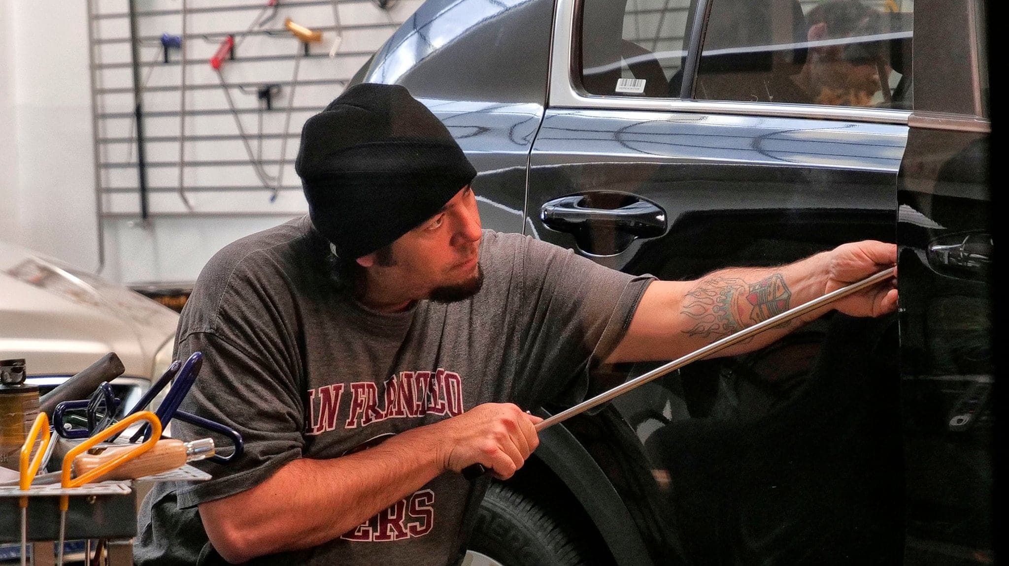 Paintless dent repair being performed on a vehicle panel