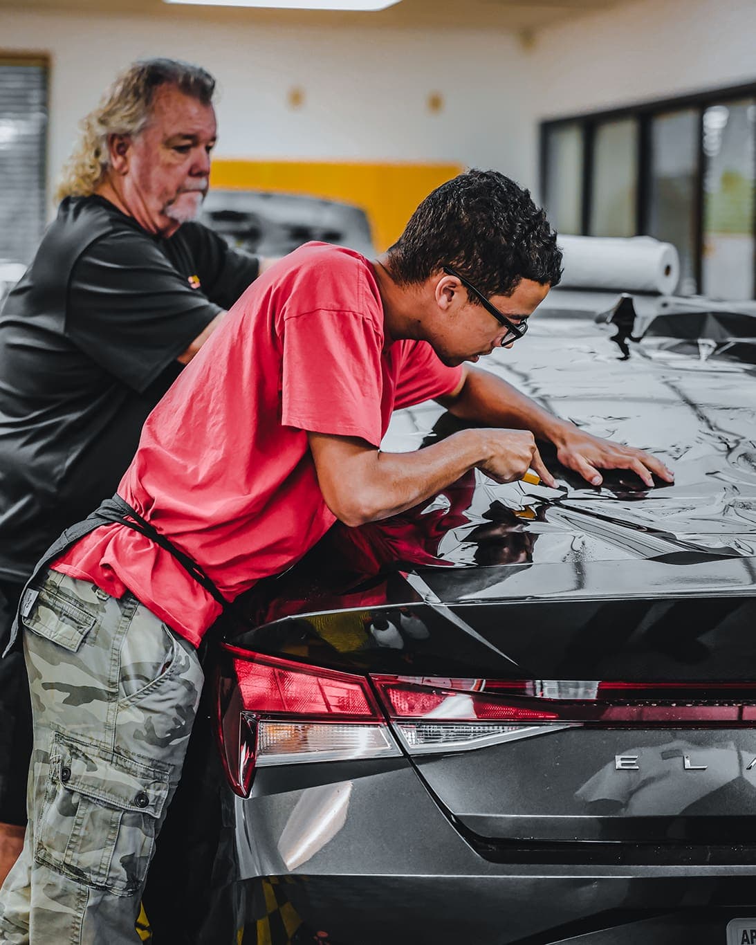 Window tint film being applied to a vehicle window